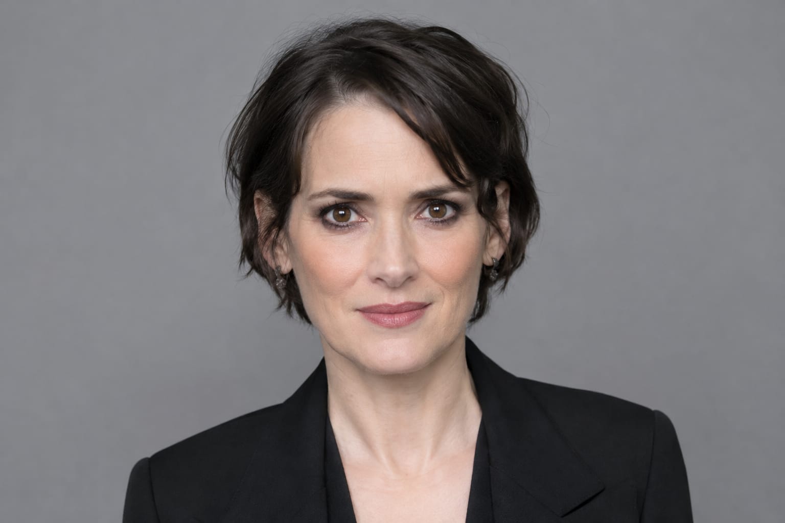 Deep wine and amber cosmic graphic with a Scorpio scorpion glyph and the words Born This Day, October 29, celebrating Winona Ryder.
